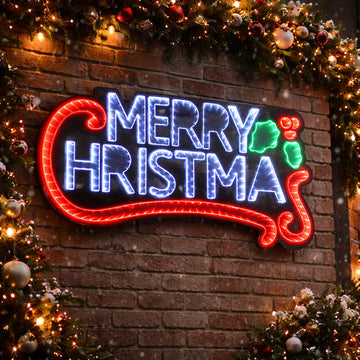 Neon 'Merry Christmas' sign on a brick wall with festive decorations.